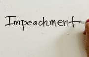 the word "impeachment" written on a white board