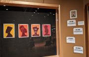 An art exhibit with silhouettes of African American women on display.