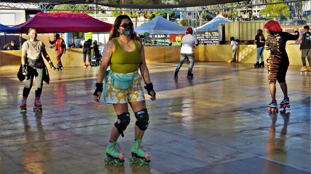Roller skaters with masks on enjoy the community skating rink.