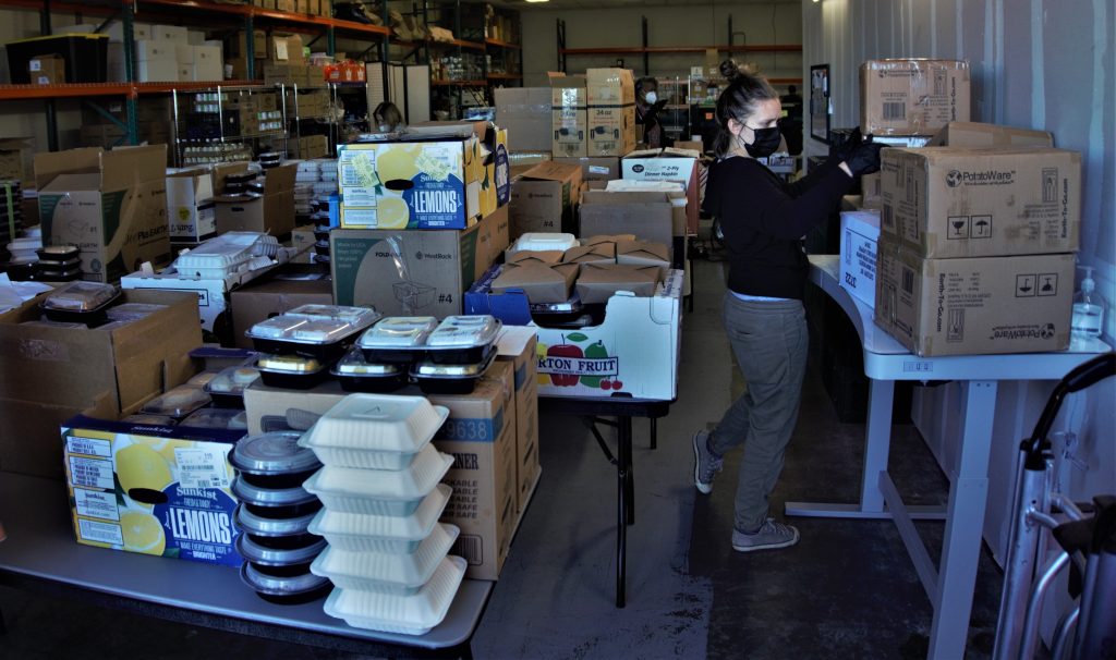 A warehouse full of packed hot meals provided by local restaurants.