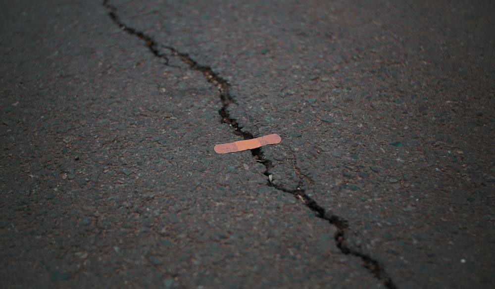 a bandaid covers a cracked ground