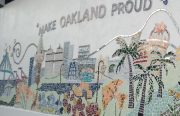a wall outside a school that says "make oakland proud"