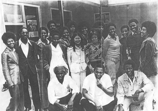 a black and white photo of a large group of African American and some Asian American teachers and schools aff standing for photo